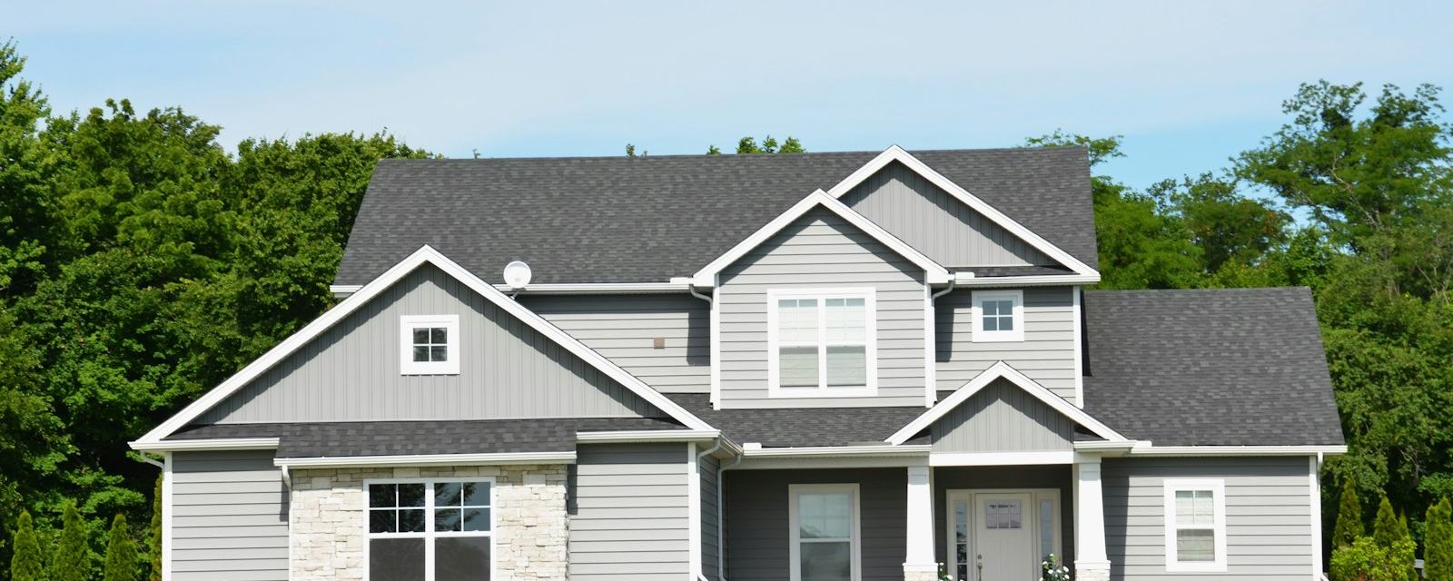 A modern two-story home with a green lawn